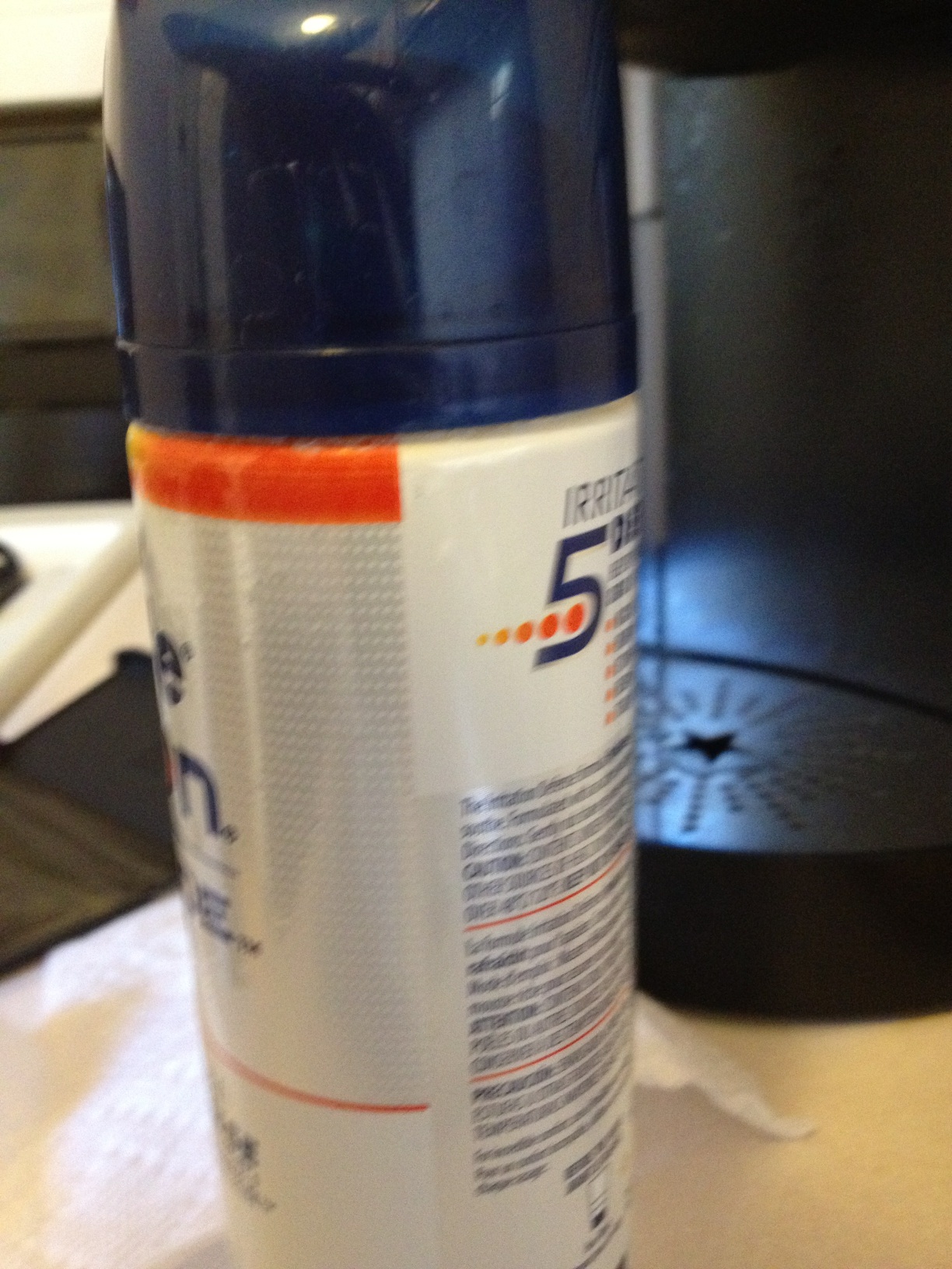 A photo captured by a person who is blind. A computer-generated caption for this photo is: A close up of a bottle on a table.