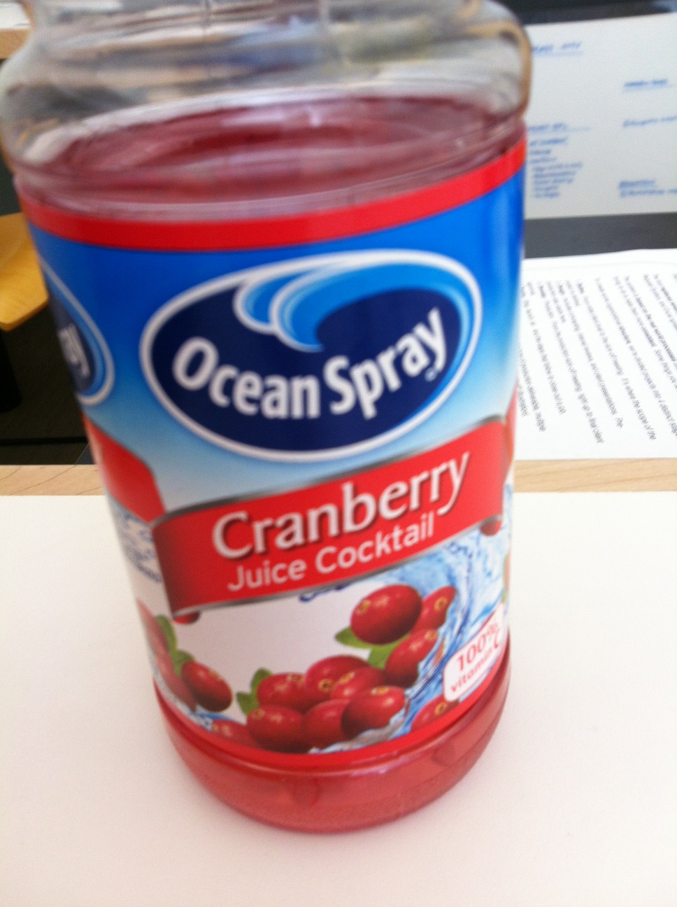 A photo captured by a person who is blind. A computer-generated caption for this photo is: A cup of fruit sitting on a table.