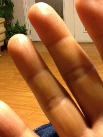 A photo captured by a person who is blind. A computer-generated caption for this photo is: A close up of a person ' s hands.