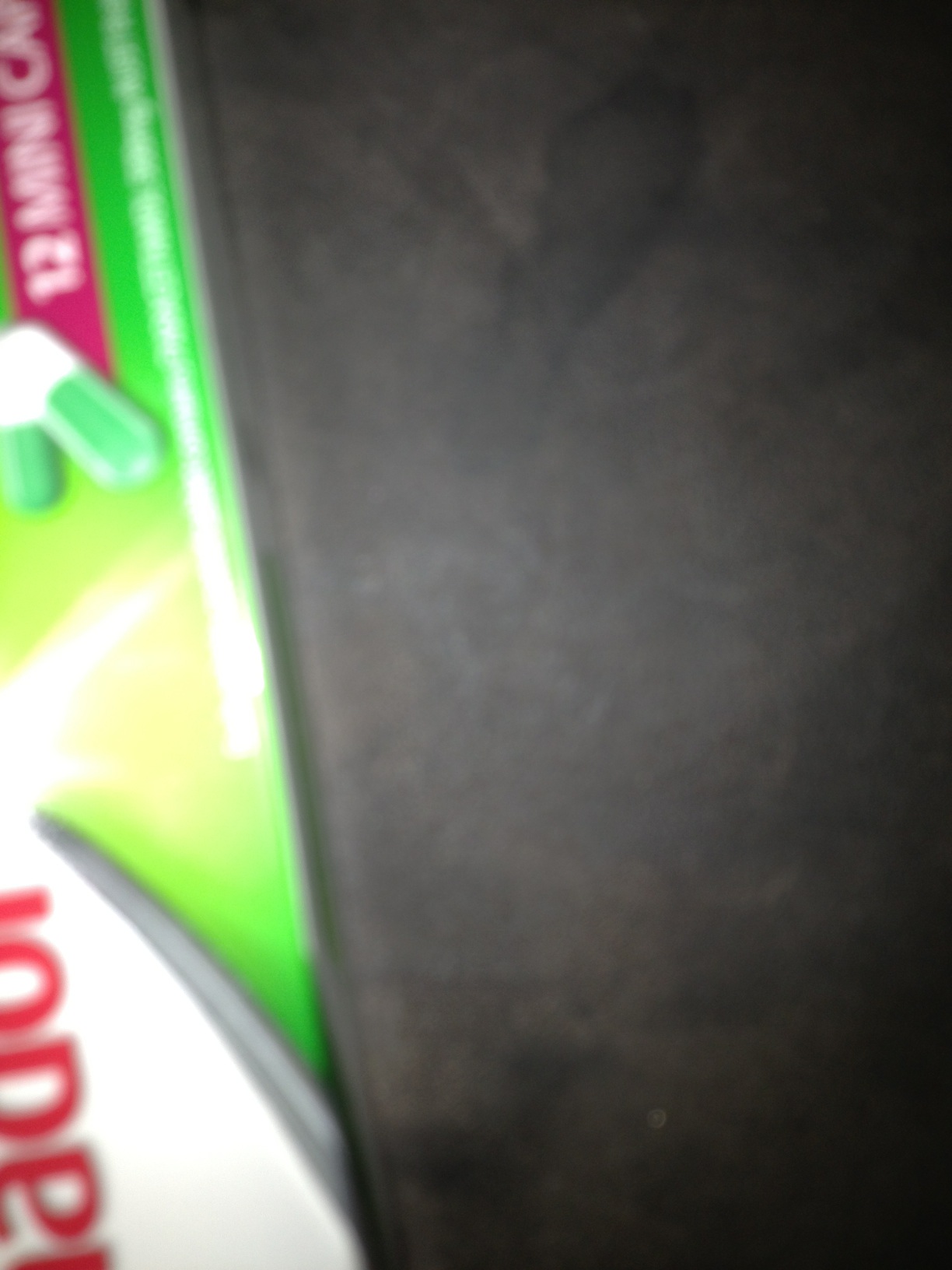 A photo captured by a person who is blind. A computer-generated caption for this photo is: A close up of a light on a table.