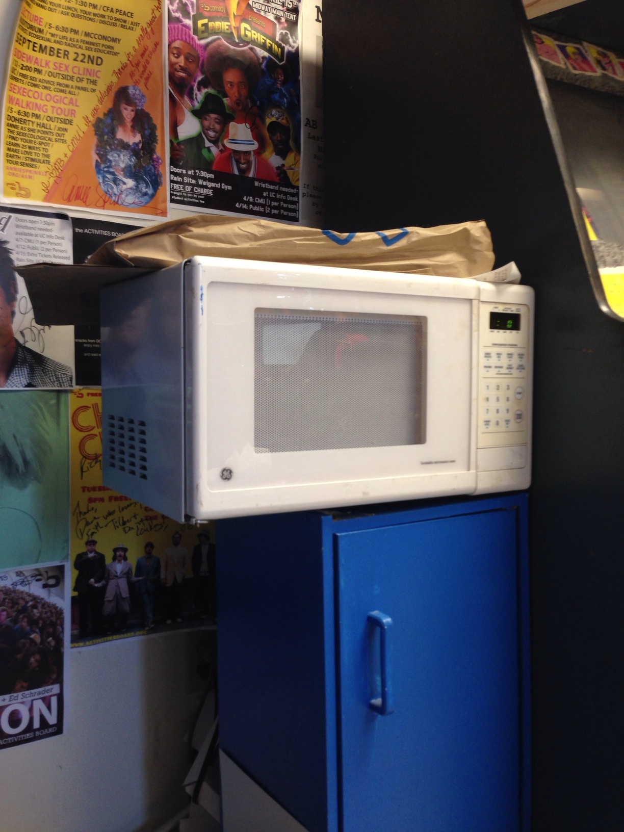 A photo captured by a person who is blind. A computer-generated caption for this photo is: A microwave sitting on top of a counter.
