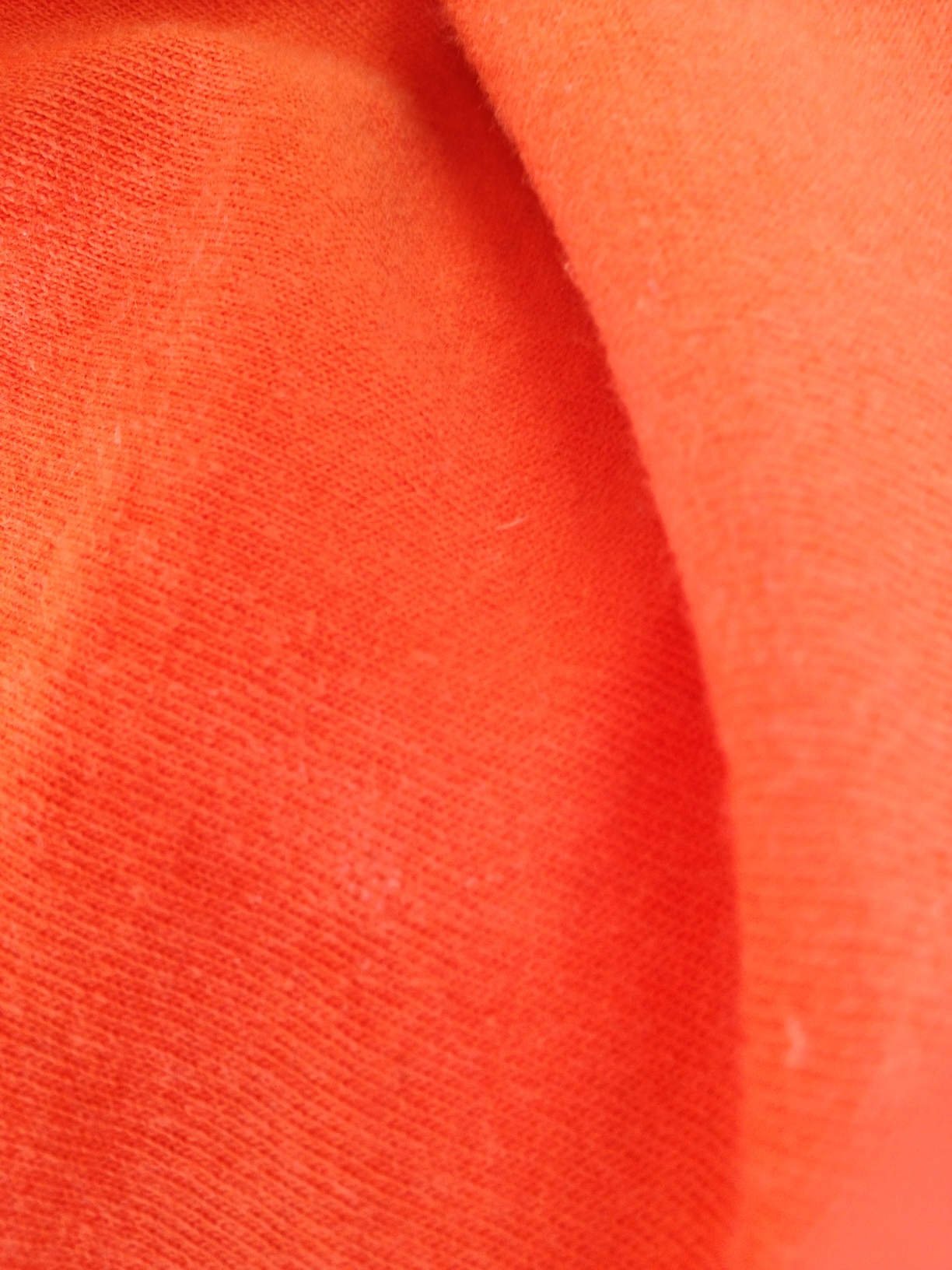 A photo captured by a person who is blind. A computer-generated caption for this photo is: A close up of a red phone.