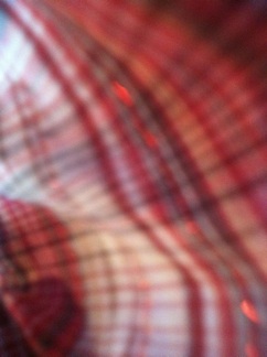 A photo captured by a person who is blind. A computer-generated caption for this photo is: A close up of a red bench.