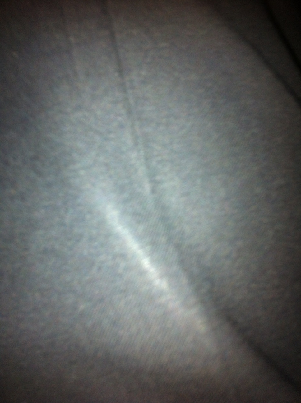 A photo captured by a person who is blind. A computer-generated caption for this photo is: A close up of a person on a floor.