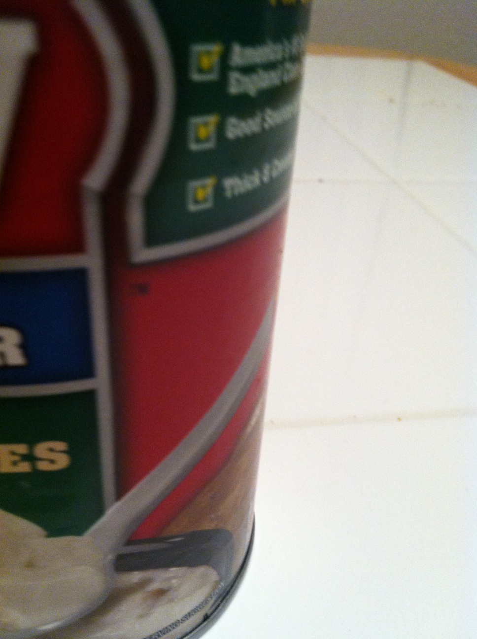 A photo captured by a person who is blind. A computer-generated caption for this photo is: A cup of food sitting on top of a table.