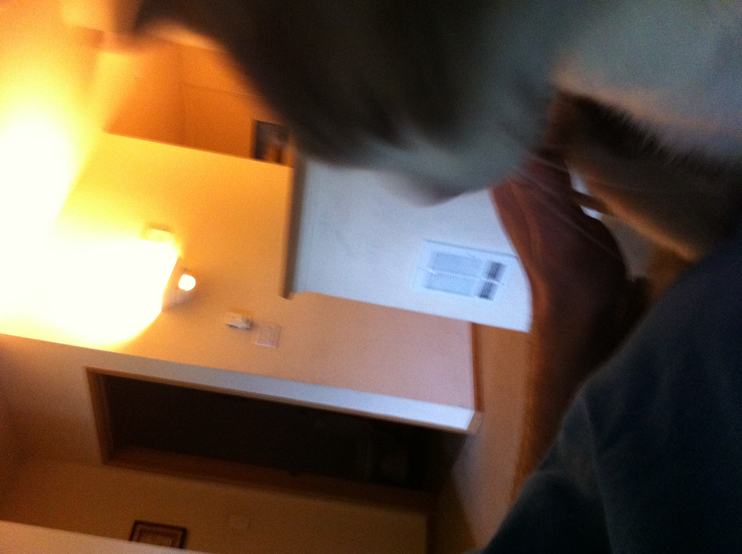 A photo captured by a person who is blind. A computer-generated caption for this photo is: A man sitting in front of a living room.
