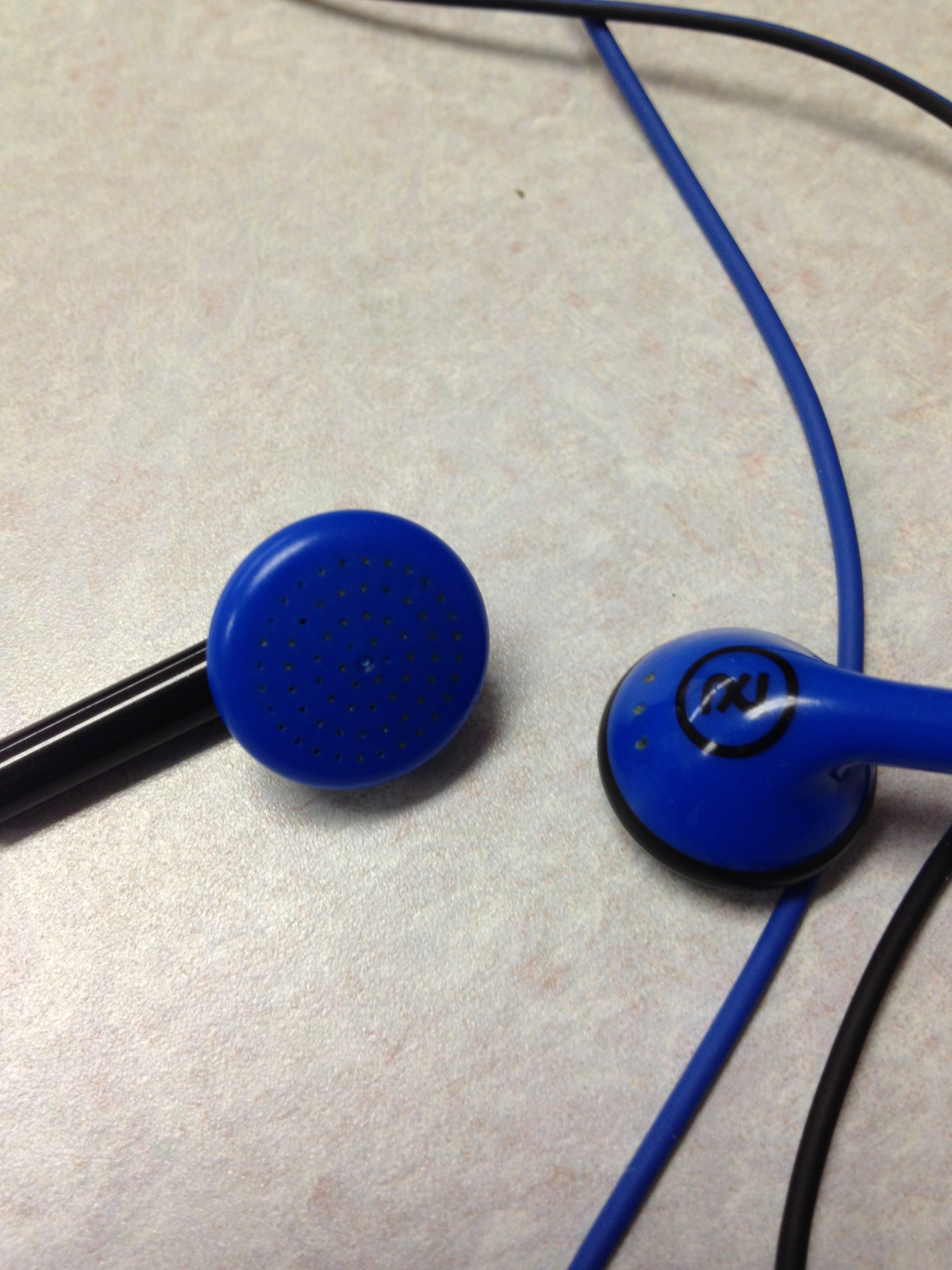 A photo captured by a person who is blind. A computer-generated caption for this photo is: A pair of scissors sitting on top of a table.