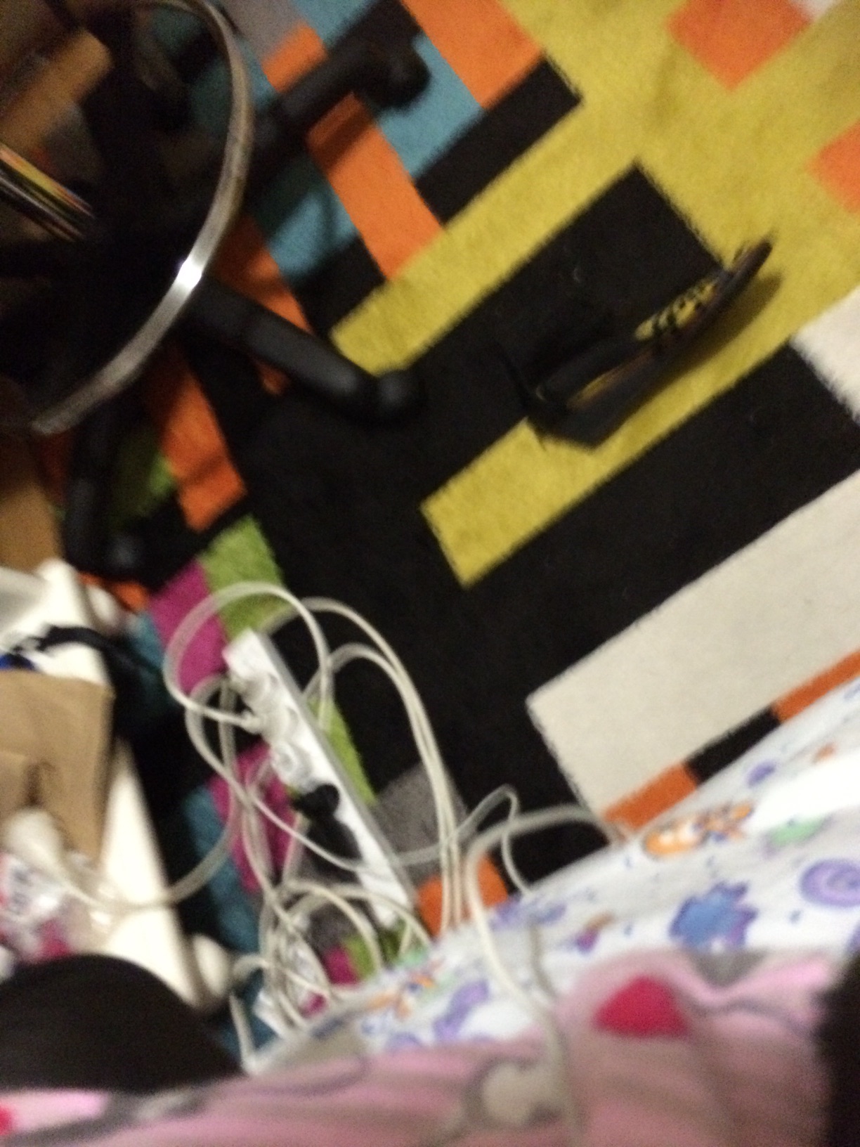 A photo captured by a person who is blind. A computer-generated caption for this photo is: A pair of scissors sitting on a bed.