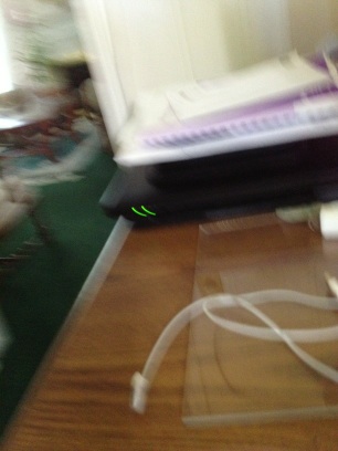A photo captured by a person who is blind. A computer-generated caption for this photo is: A laptop sitting on top of a wooden table.