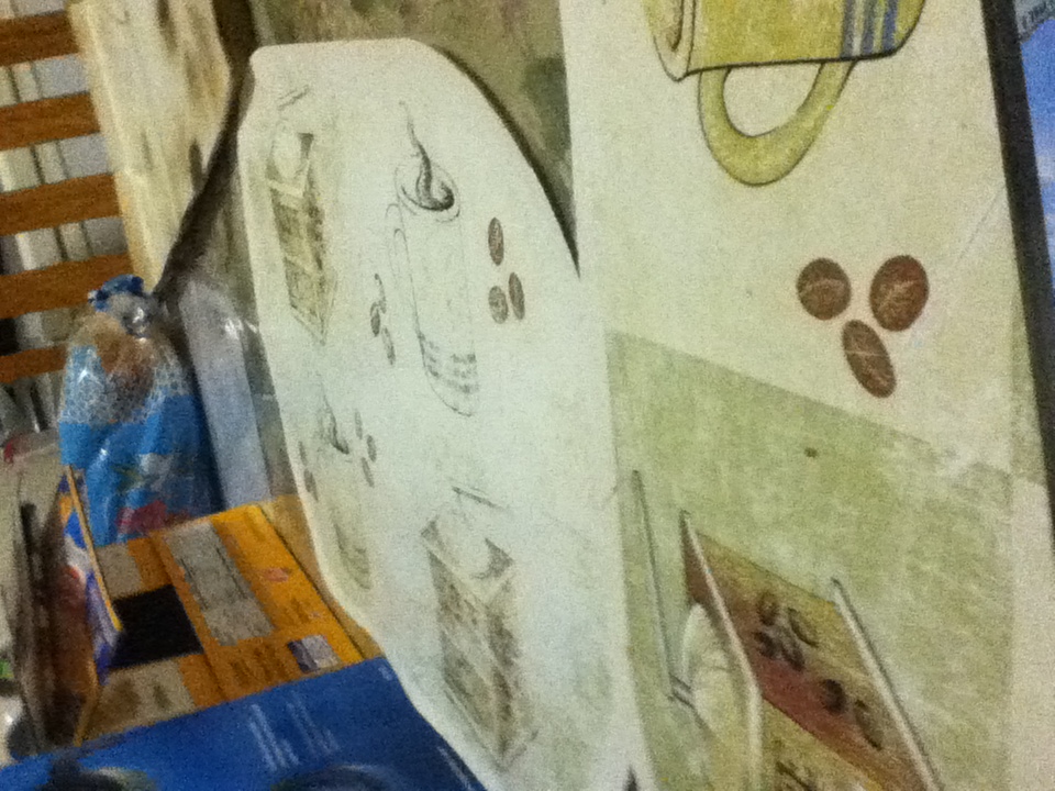 A photo captured by a person who is blind. A computer-generated caption for this photo is: A picture of a table with a cup of scissors.