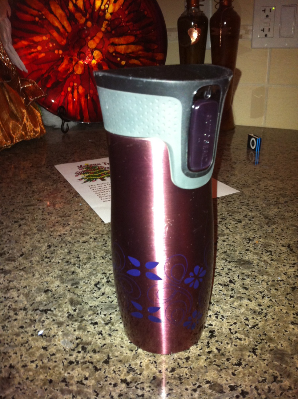 A photo captured by a person who is blind. A computer-generated caption for this photo is: A close up of a cup on a table.