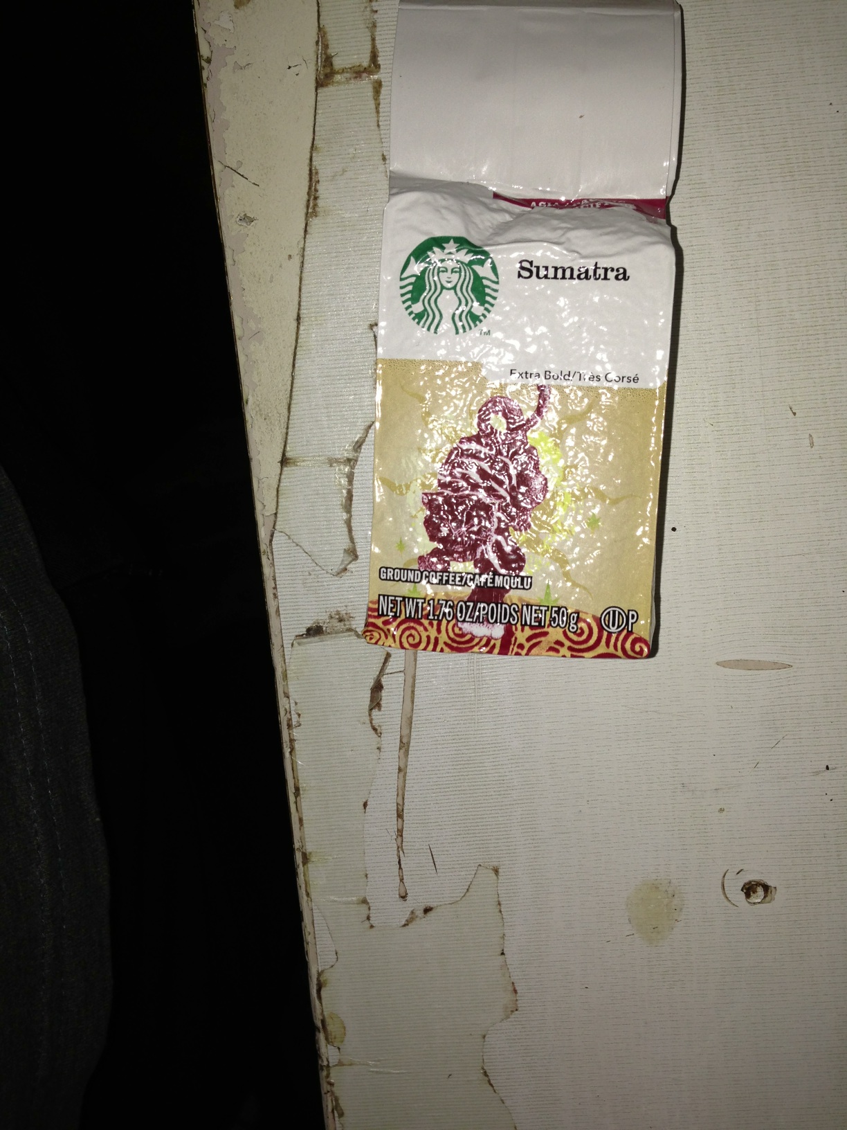 A photo captured by a person who is blind. A computer-generated caption for this photo is: A picture of a wall with a sign on it.