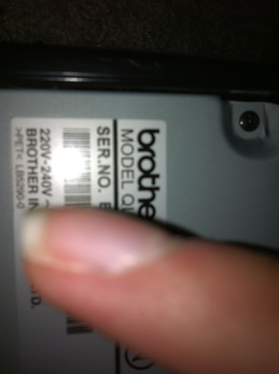 A photo captured by a person who is blind. A computer-generated caption for this photo is: A person ' s hand holding a remote.