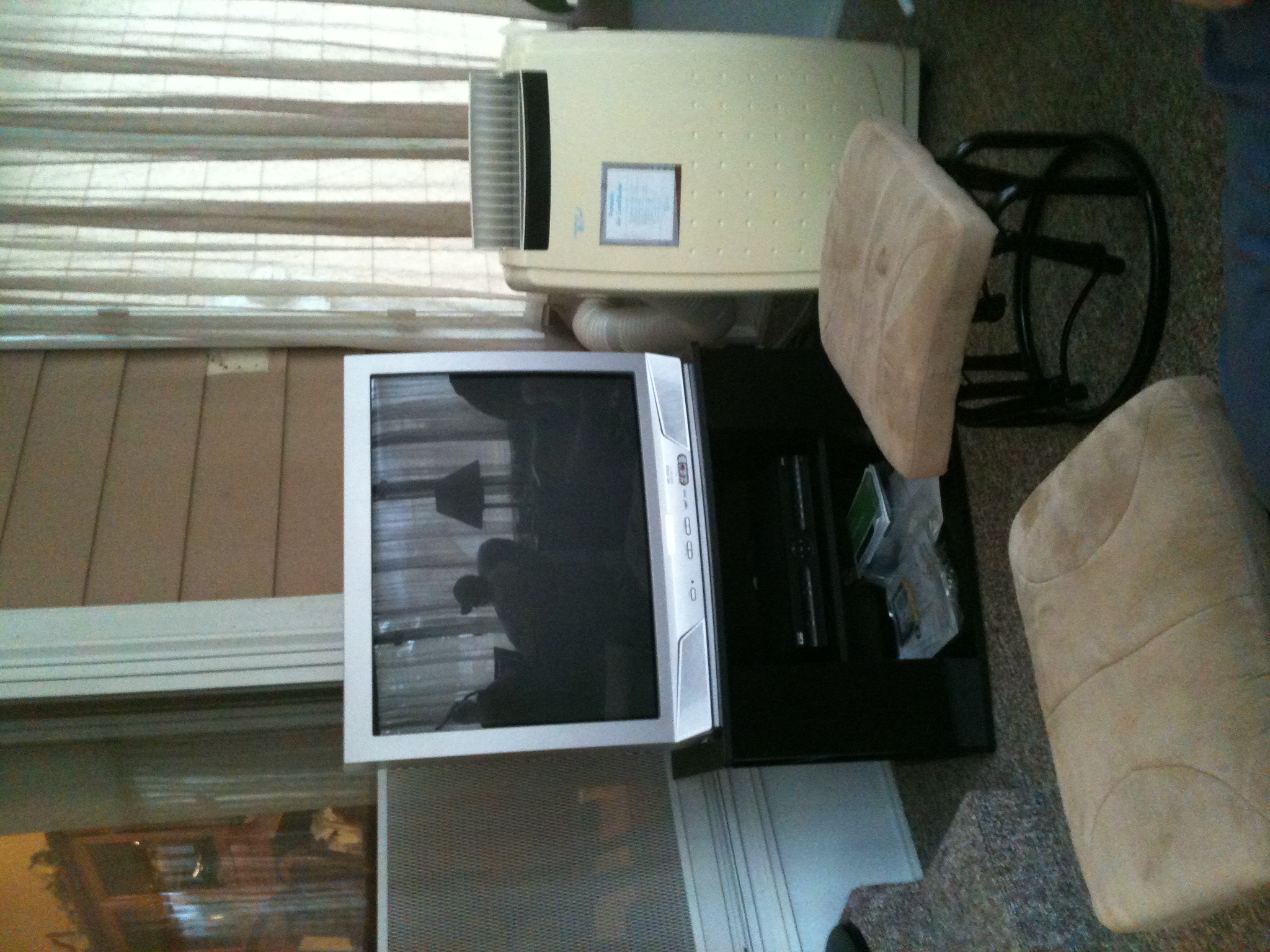 A photo captured by a person who is blind. A computer-generated caption for this photo is: A living room with a television and a chair.