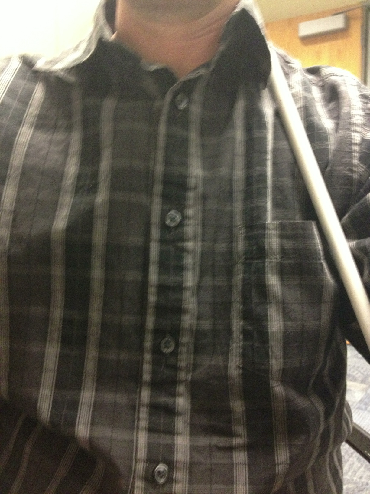 A photo captured by a person who is blind. A computer-generated caption for this photo is: A man that is holding a baseball bat.