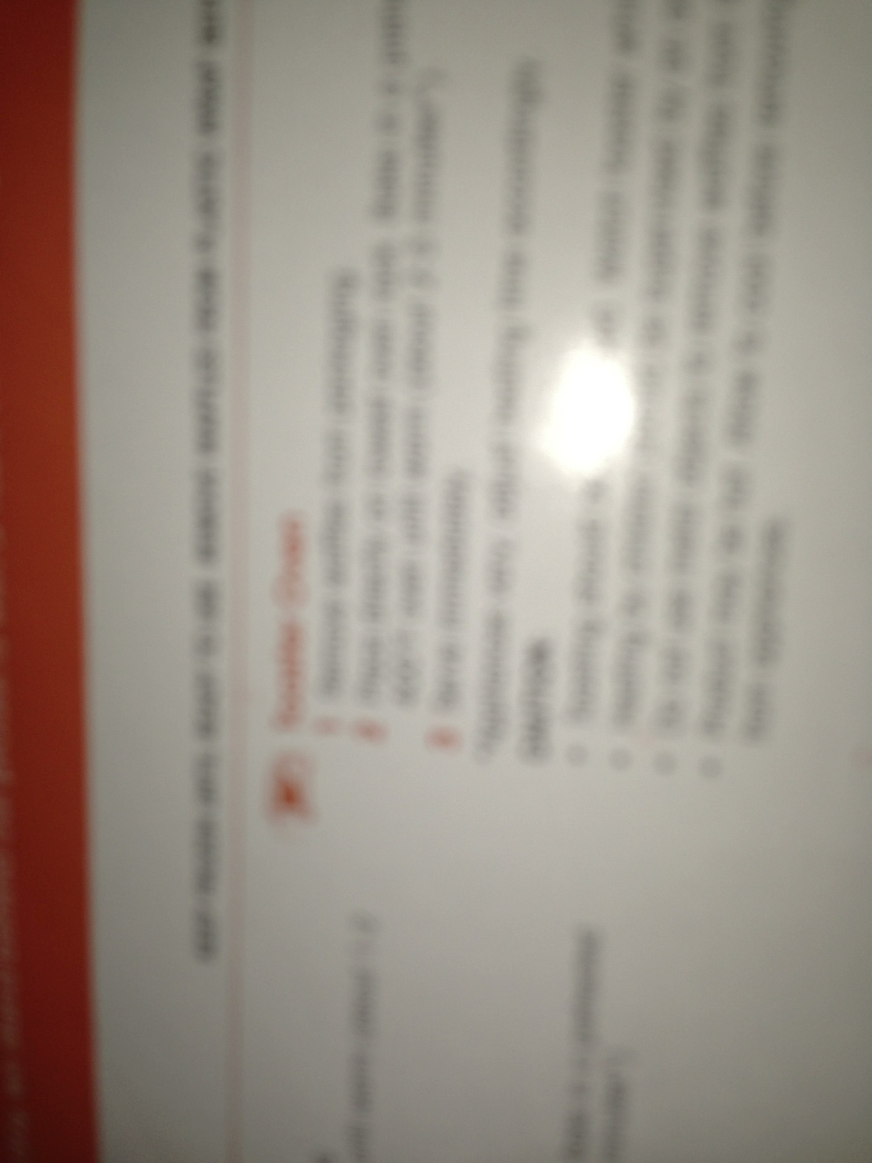 A photo captured by a person who is blind. A computer-generated caption for this photo is: A close up of a sign with a light on it.