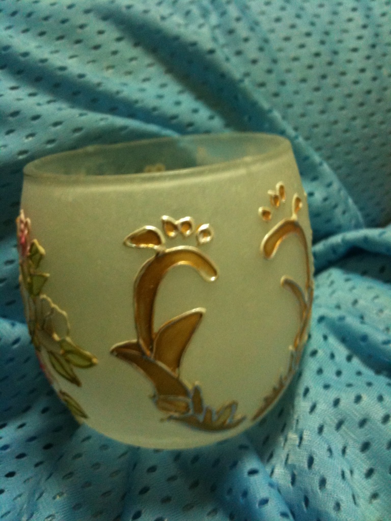 A photo captured by a person who is blind. A computer-generated caption for this photo is: A close up of a cup on a table.