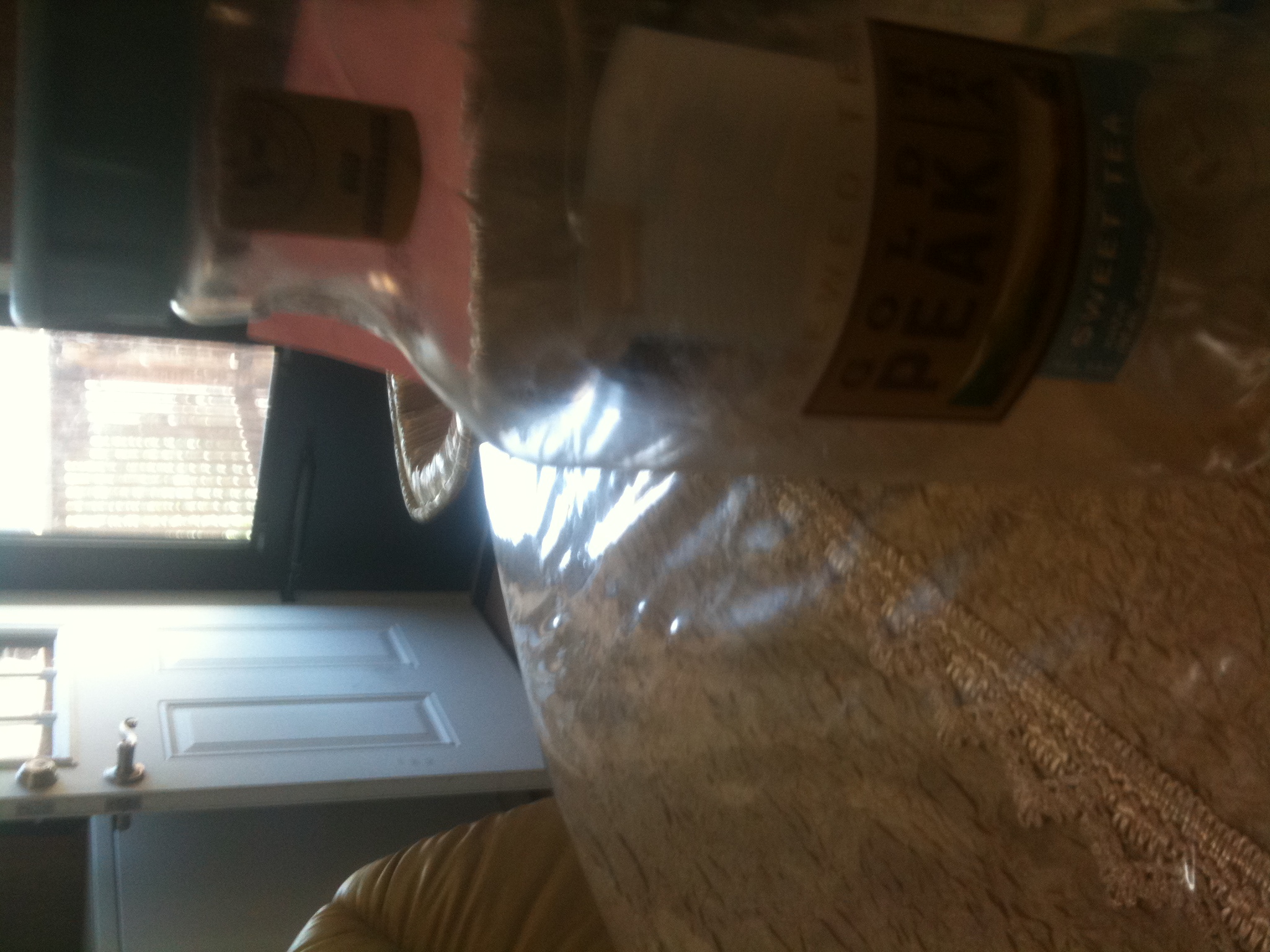 A photo captured by a person who is blind. A computer-generated caption for this photo is: A close up of a blender on a table.