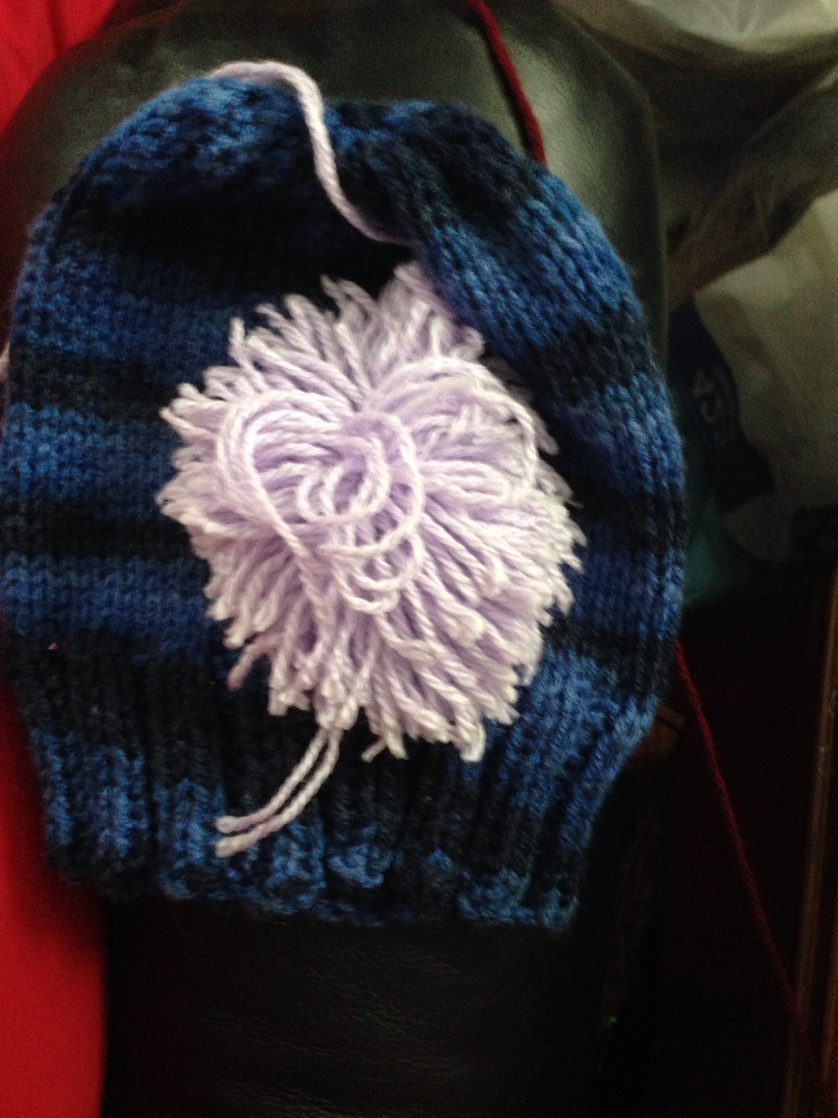 A photo captured by a person who is blind. A computer-generated caption for this photo is: A close up of a blue blanket on a bed.