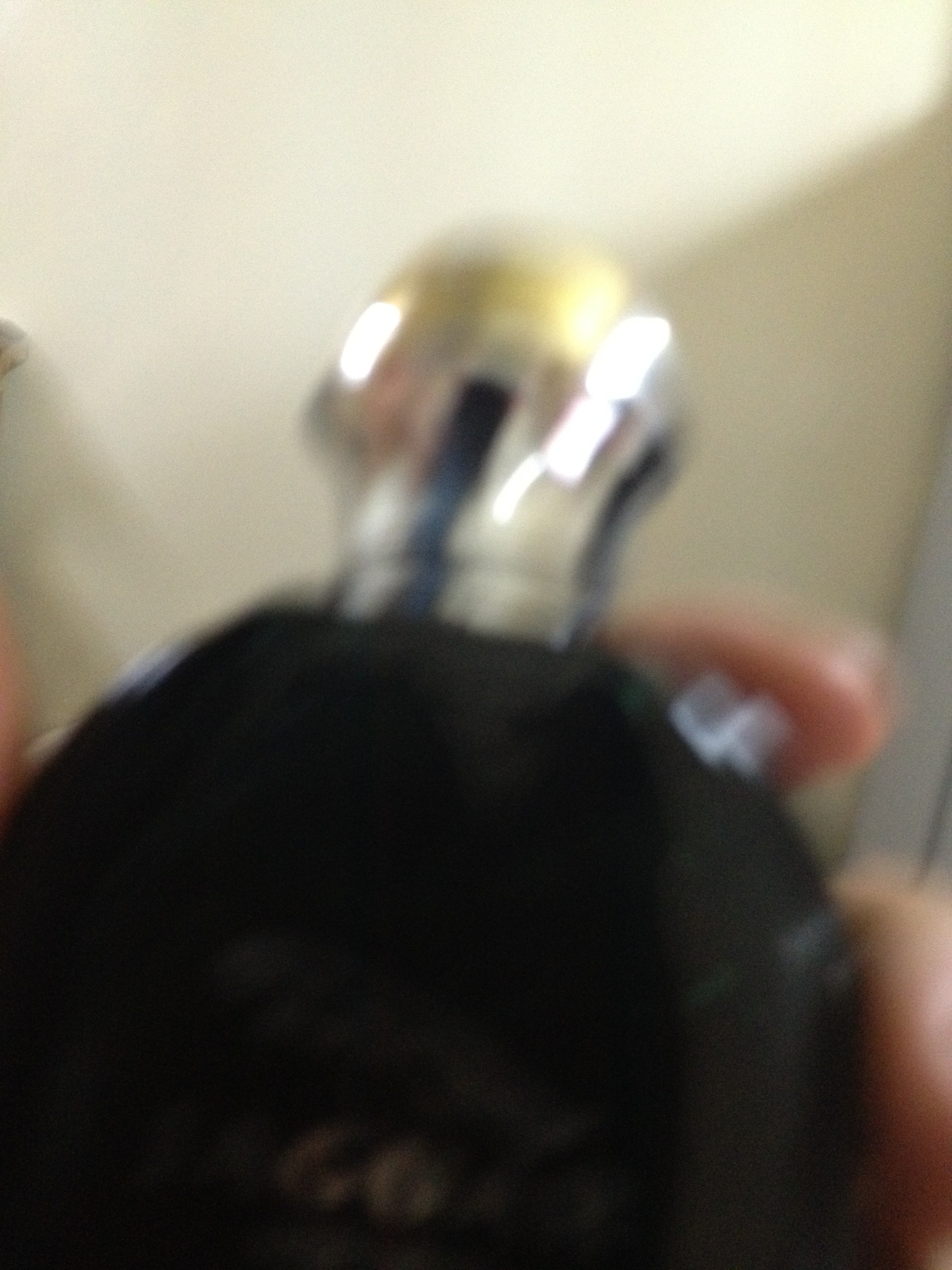 A photo captured by a person who is blind. A computer-generated caption for this photo is: A close up of a person in a room.