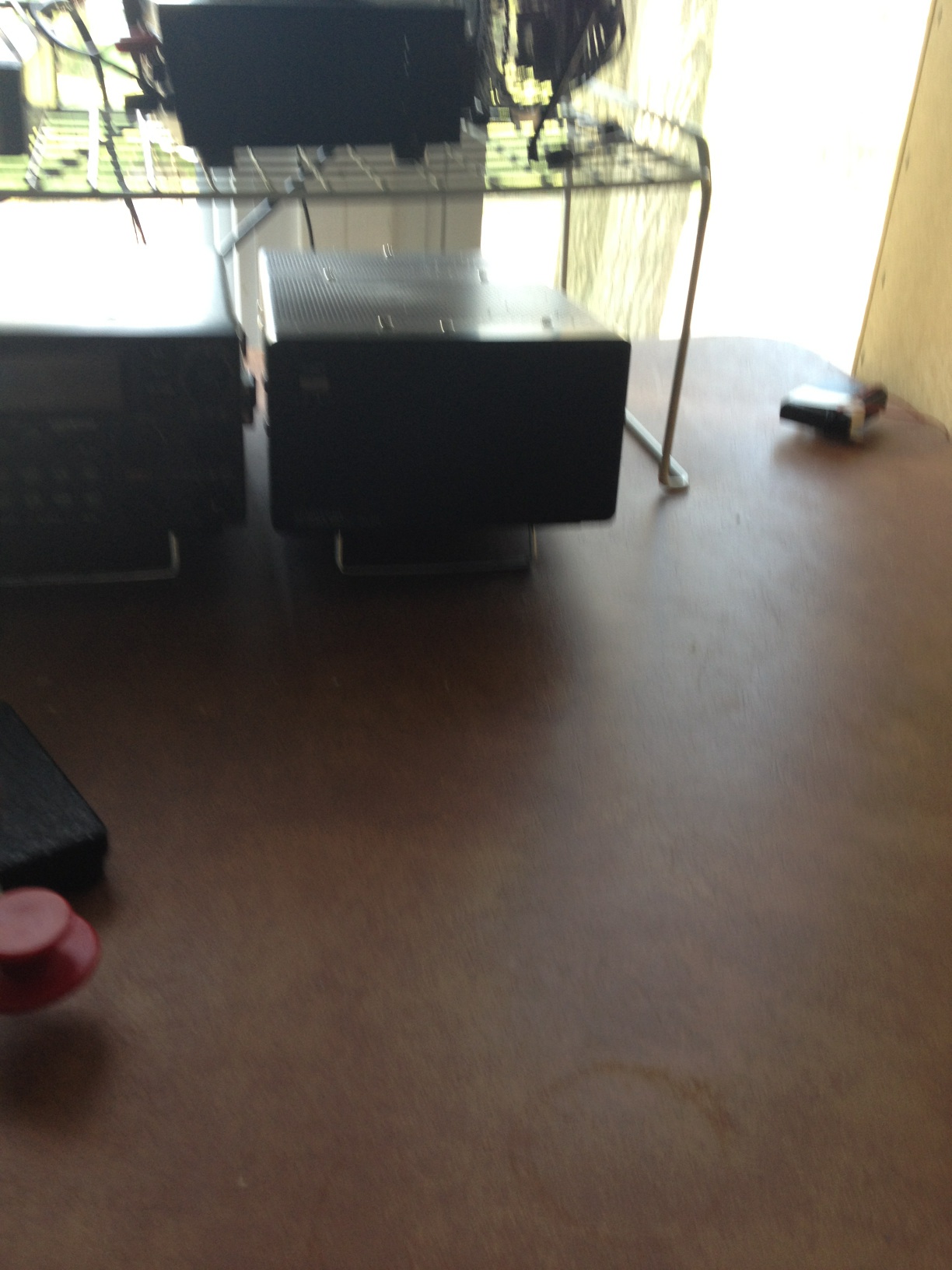 A photo captured by a person who is blind. A computer-generated caption for this photo is: A suitcase in a room with a black floor.