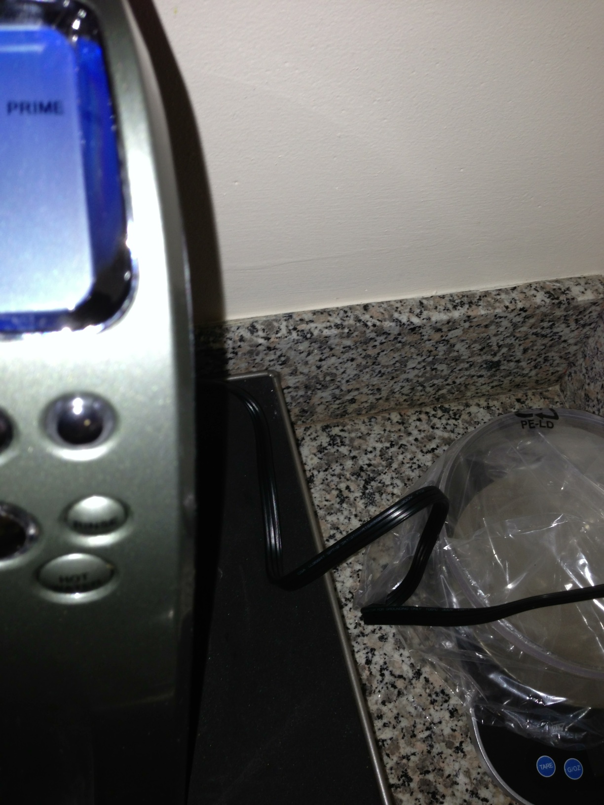 A photo captured by a person who is blind. A computer-generated caption for this photo is: A close up of a sink with a toaster on it.