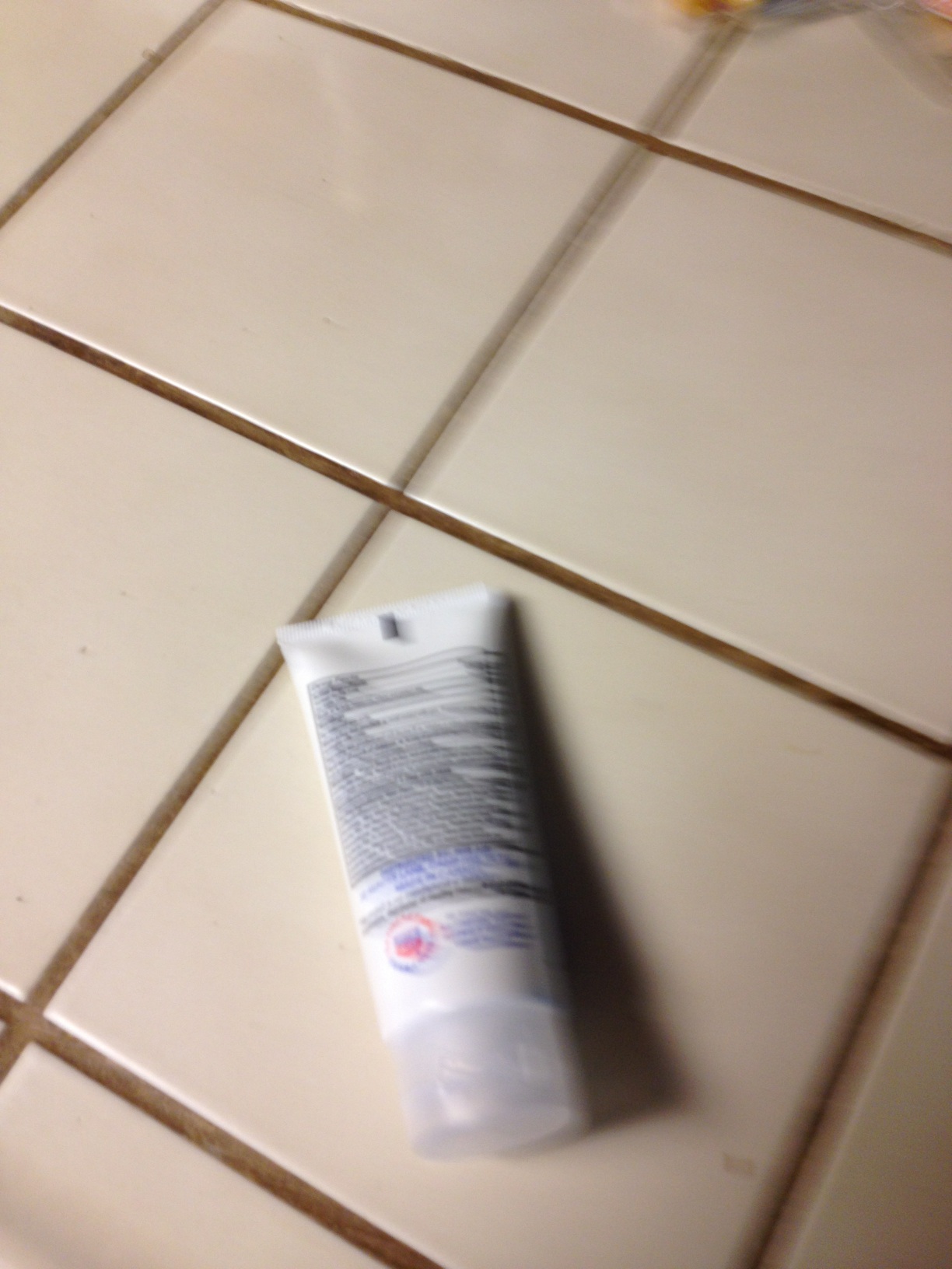 A photo captured by a person who is blind. A computer-generated caption for this photo is: A bottle of water sitting on top of a counter.