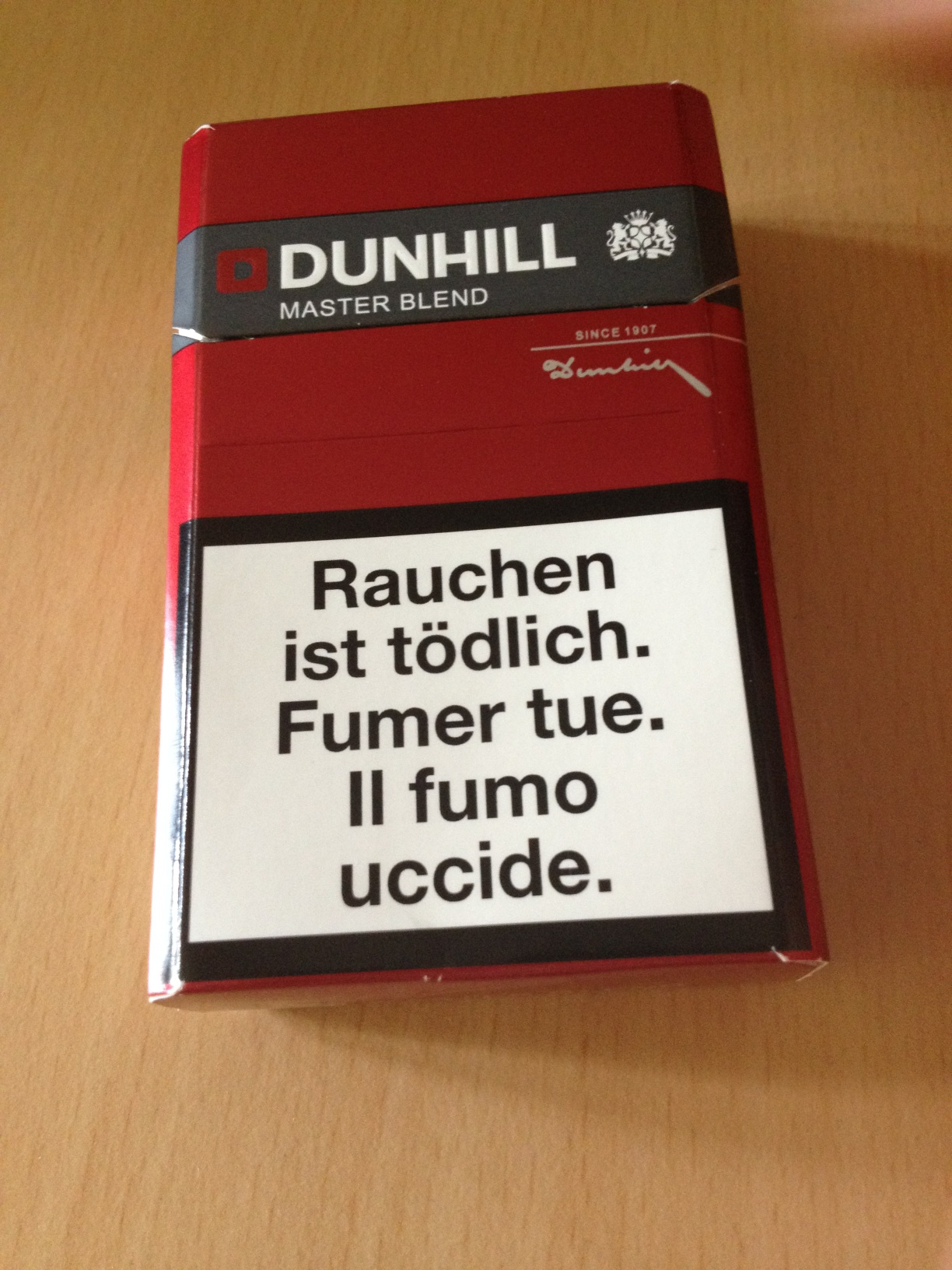 A photo captured by a person who is blind. A computer-generated caption for this photo is: A red and white sign on a table.