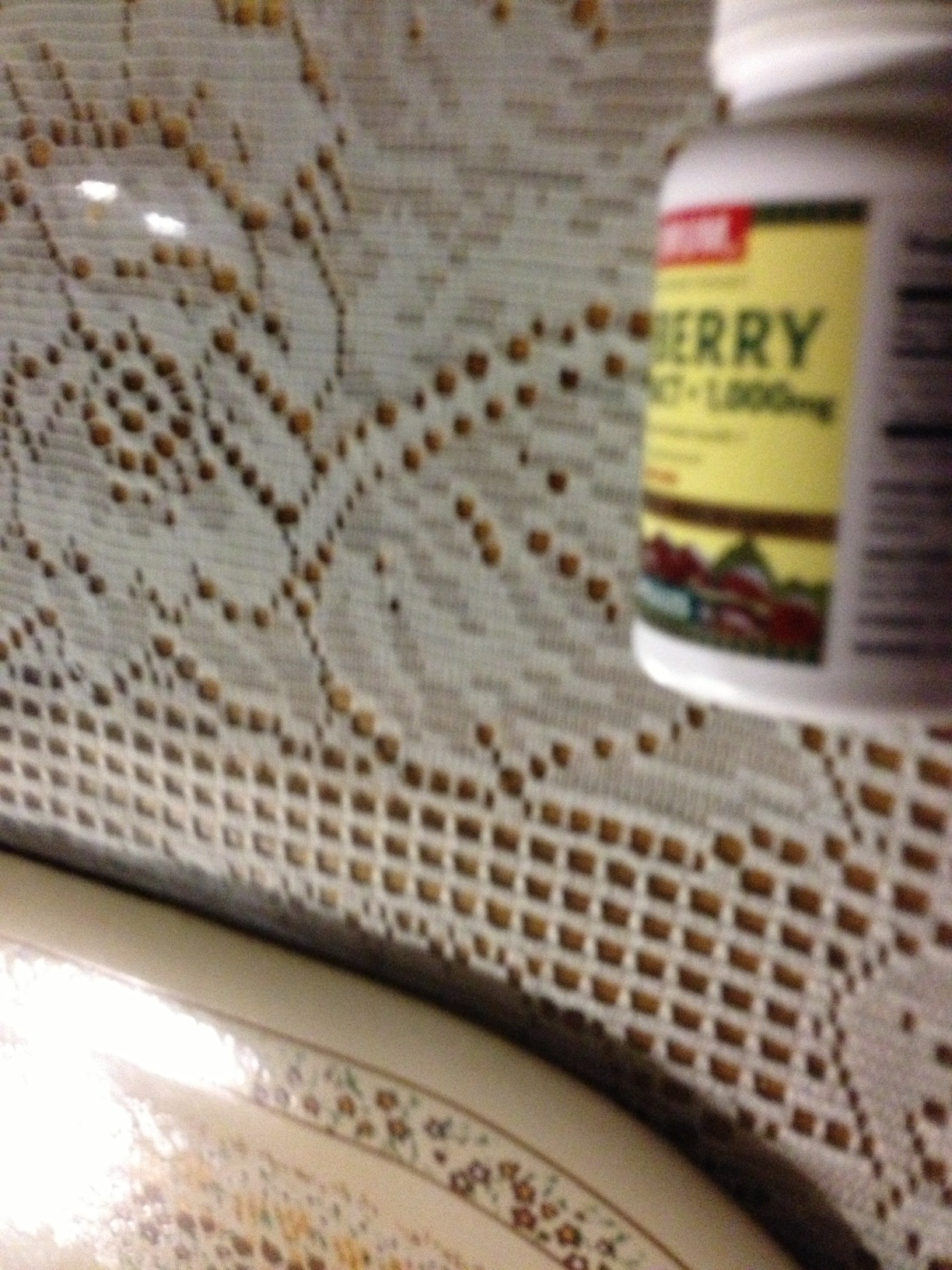 A photo captured by a person who is blind. A computer-generated caption for this photo is: A close up of a cup on a table.