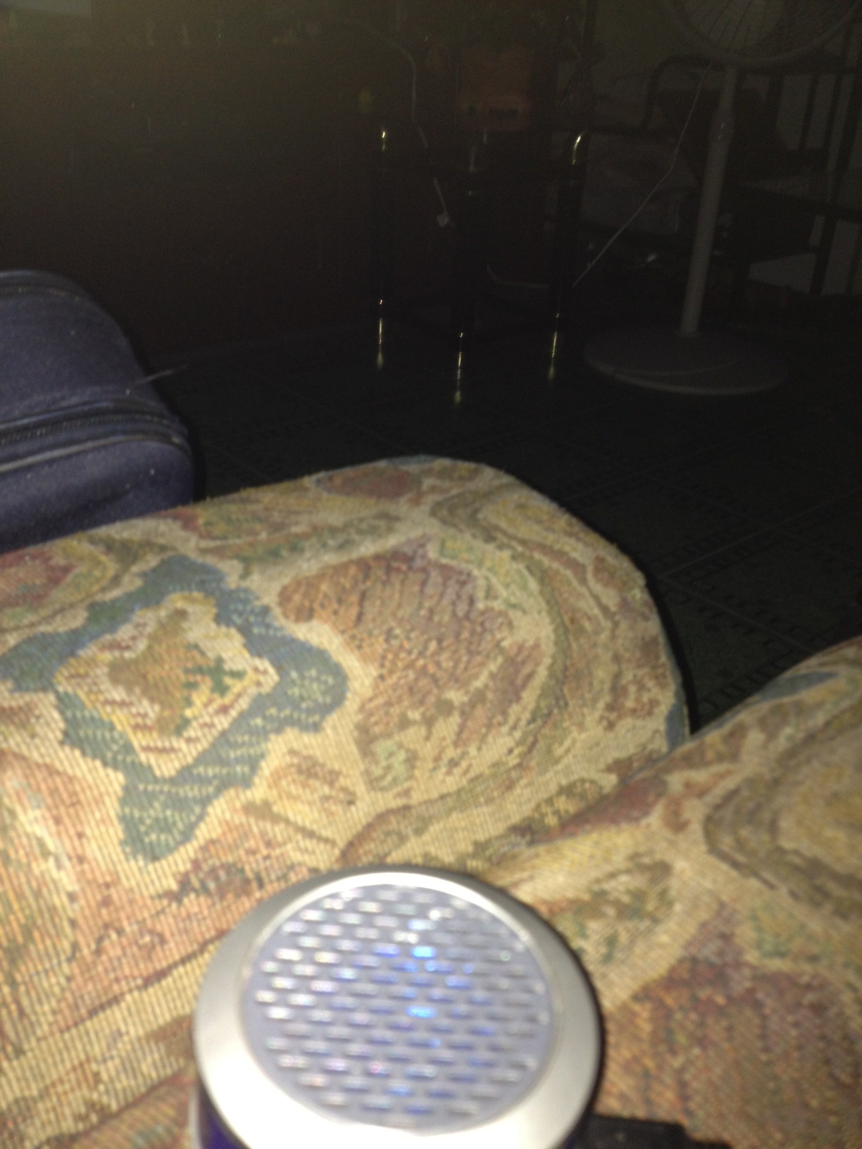 A photo captured by a person who is blind. A computer-generated caption for this photo is: A close up of a couch with a blanket.