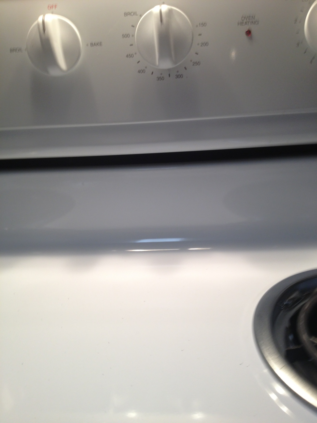 A photo captured by a person who is blind. A computer-generated caption for this photo is: A close up of a white oven and a microwave.