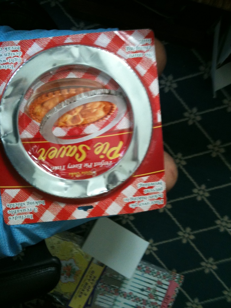 A photo captured by a person who is blind. A computer-generated caption for this photo is: A close up of a pizza on a table.