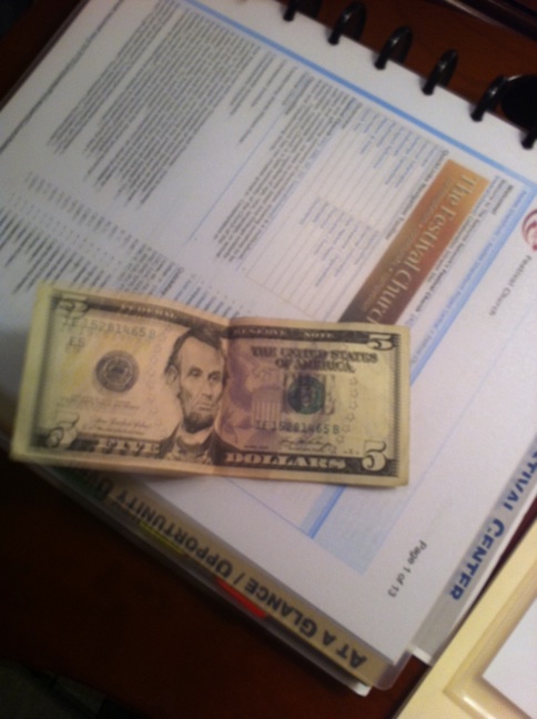 A photo captured by a person who is blind. A computer-generated caption for this photo is: A book with a picture of books on it.