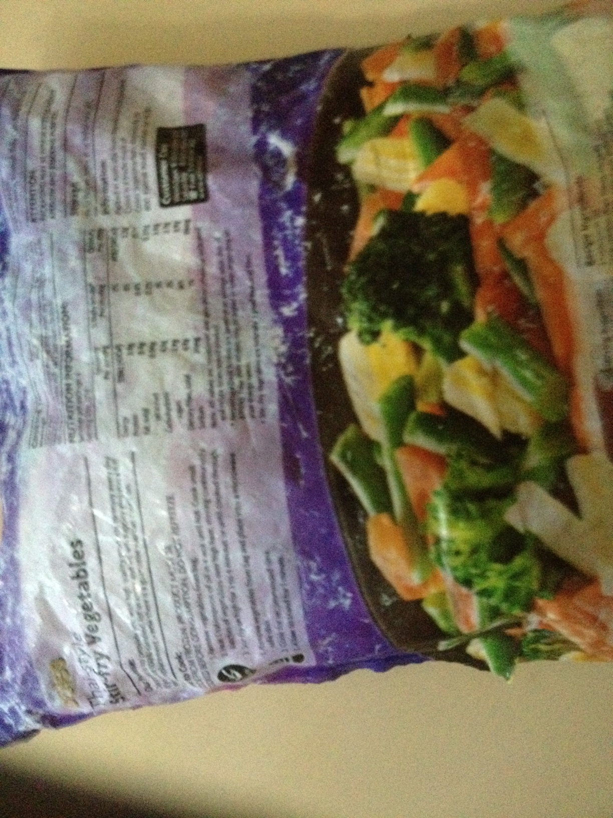 A photo captured by a person who is blind. A computer-generated caption for this photo is: A close up of a salad on a table.