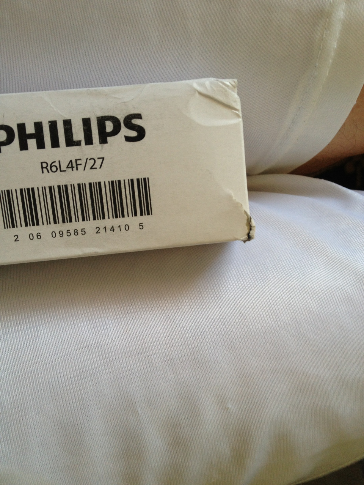 A photo captured by a person who is blind. A computer-generated caption for this photo is: A book sitting on top of a bed.