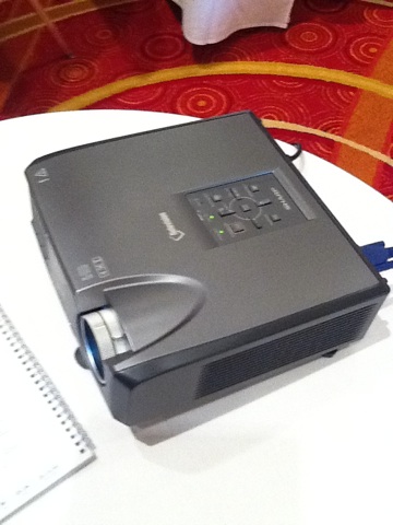 A photo captured by a person who is blind. A computer-generated caption for this photo is: A close up of a laptop on a table.