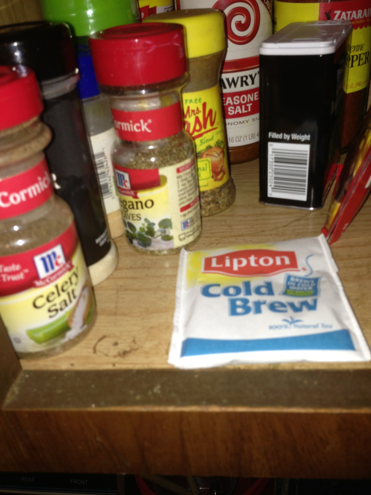 A photo captured by a person who is blind. A computer-generated caption for this photo is: A wooden counter topped with lots of food.
