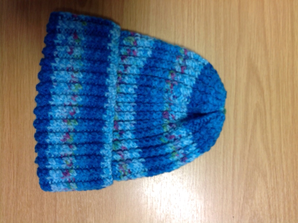 A photo captured by a person who is blind. A computer-generated caption for this photo is: A blue towel laying on a wooden floor.