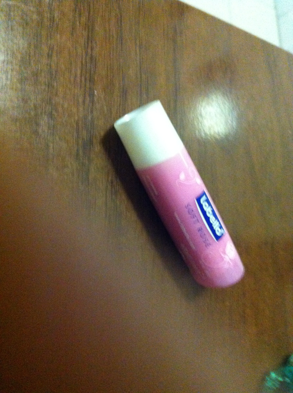 A photo captured by a person who is blind. A computer-generated caption for this photo is: A bottle of a toothbrush on a table.