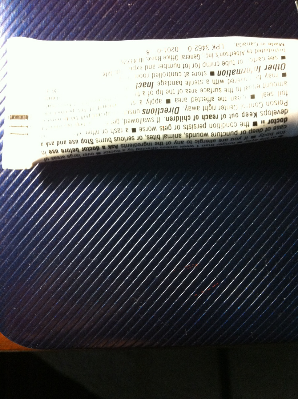 A photo captured by a person who is blind. A computer-generated caption for this photo is: A book is sitting on the side of a bed.