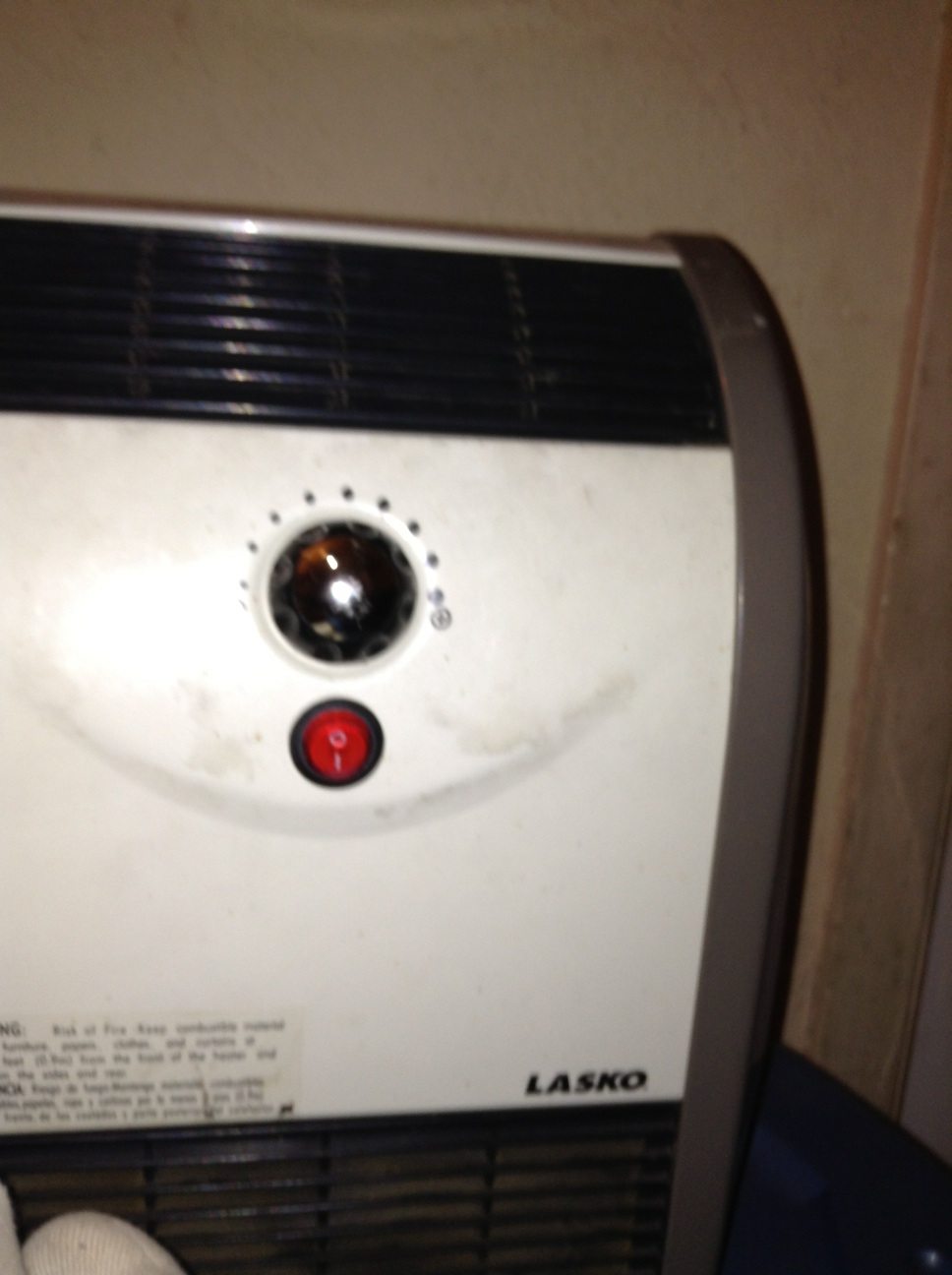 A photo captured by a person who is blind. A computer-generated caption for this photo is: A close up of a toaster on a wall.