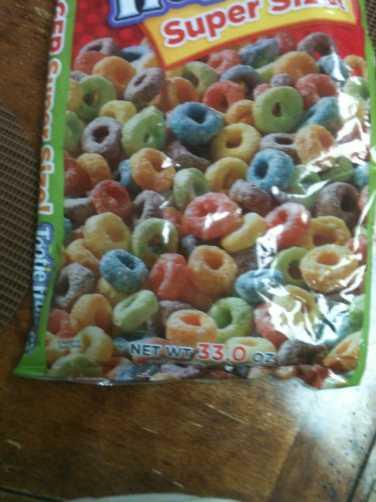 A photo captured by a person who is blind. A computer-generated caption for this photo is: A close up of a box of donuts.